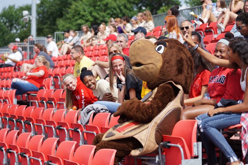 Mascot With Students in Bleachers