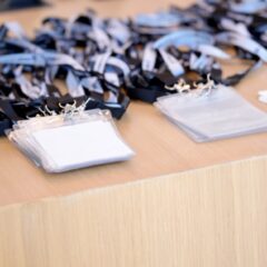 A close-up of a registration booth at a trade show with name tags attached to branded lanyards