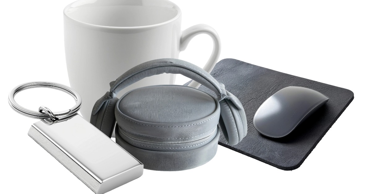 A collection of promotional items ready for custom branding. There is a mouse, a mug, headphones, and a keychain.