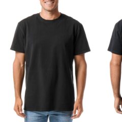 A male model stands against an all-white backdrop as he poses with a black T-shirt The shirt is for custom designs