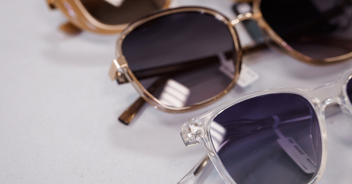 A close-up of a table holding multiple pair of sunglasses. The sunglasses are used for promotional product giveaways.