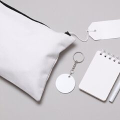 A set of promotional products sit on a gray background The products are white and ready for customization